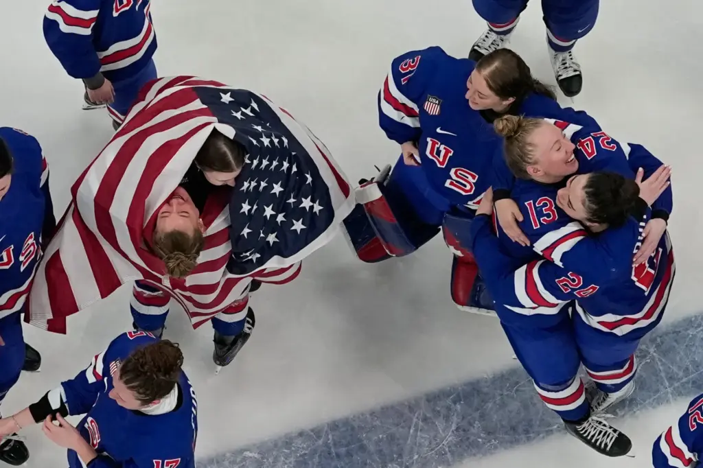 Team United States players celebrate after beating Canada 2-1 in...