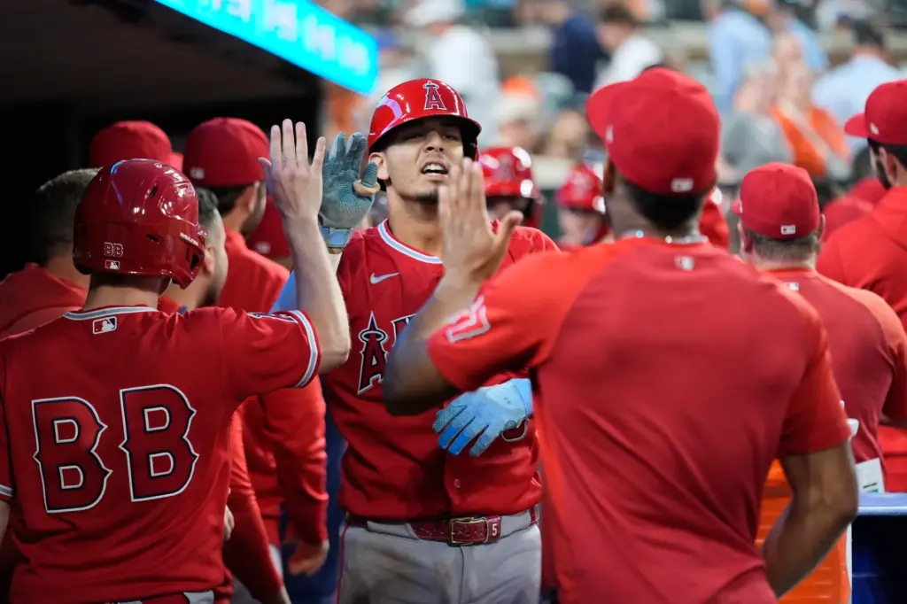 The Angels’ Vaughn Grissom, center, celebrates in the dugout after...