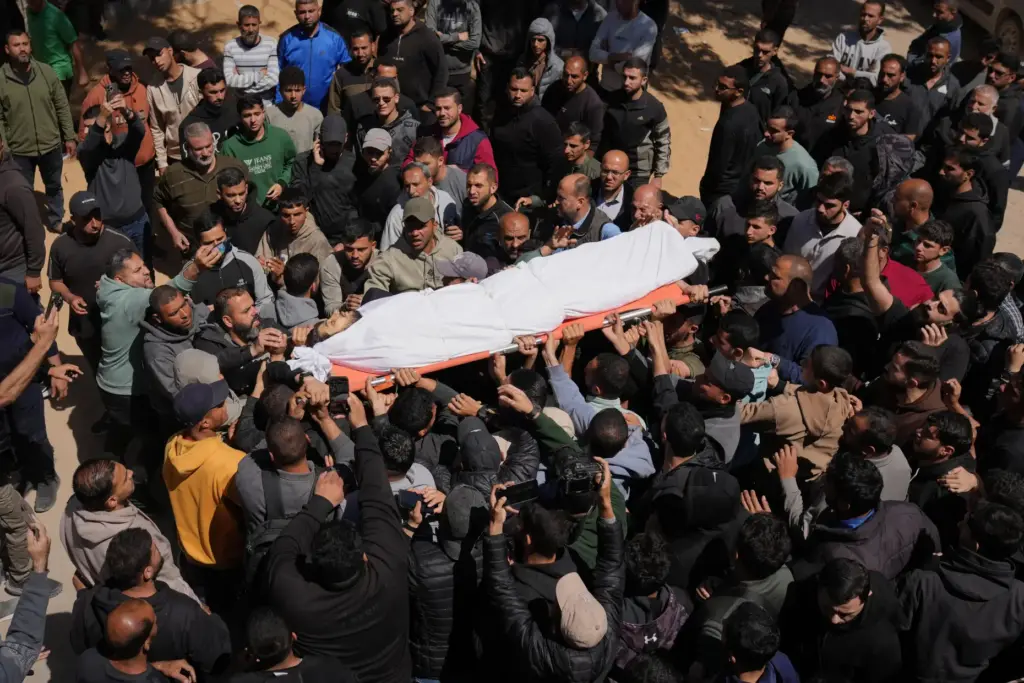 Mourners carry the body of Azzam al-Hayya, son of Hamas leader Khalil al-Hayya.