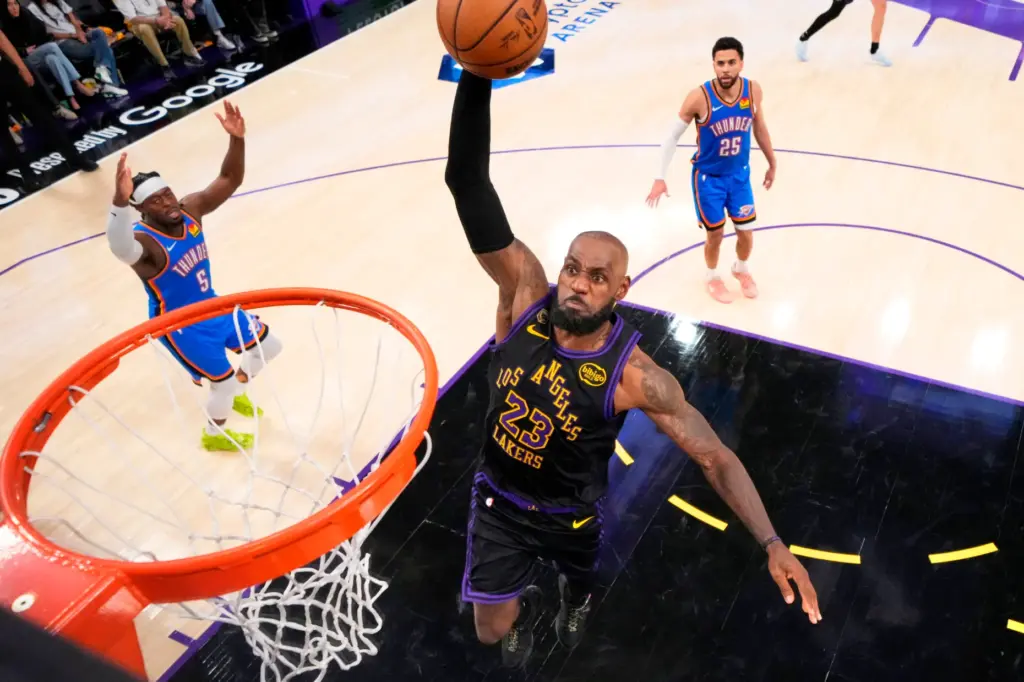 Lakers star LeBron James goes up for a dunk as...