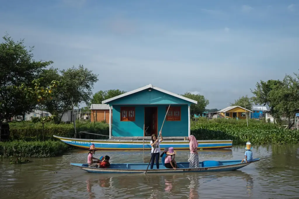 The children are transported by boat to go to school...