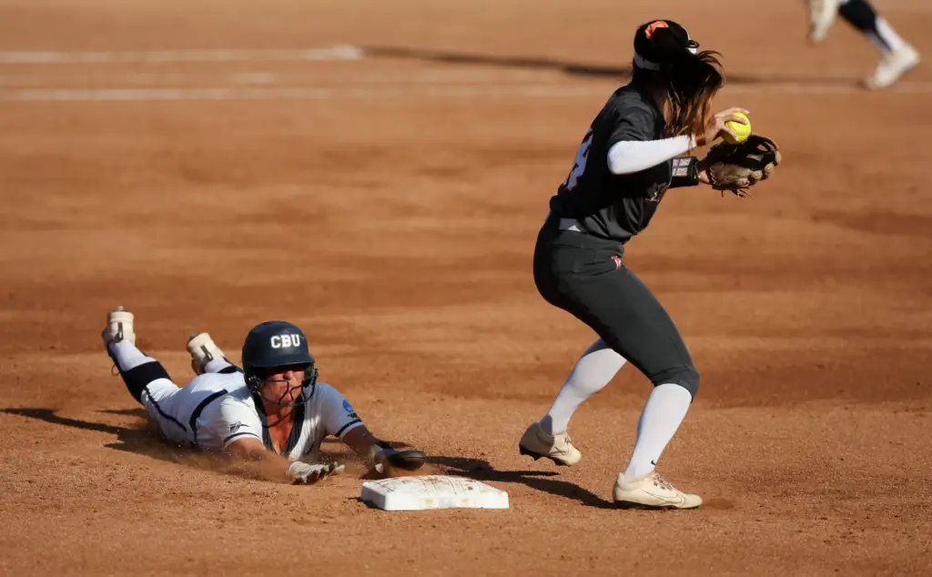 California Baptistâs Ashlee Annett, left, is late with the slide...