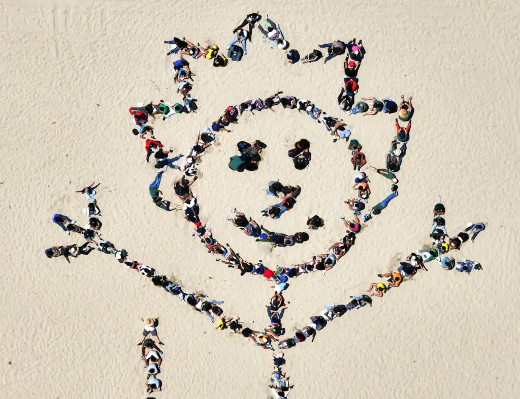 Over 1,000 kids form a giant artwork in the sand...