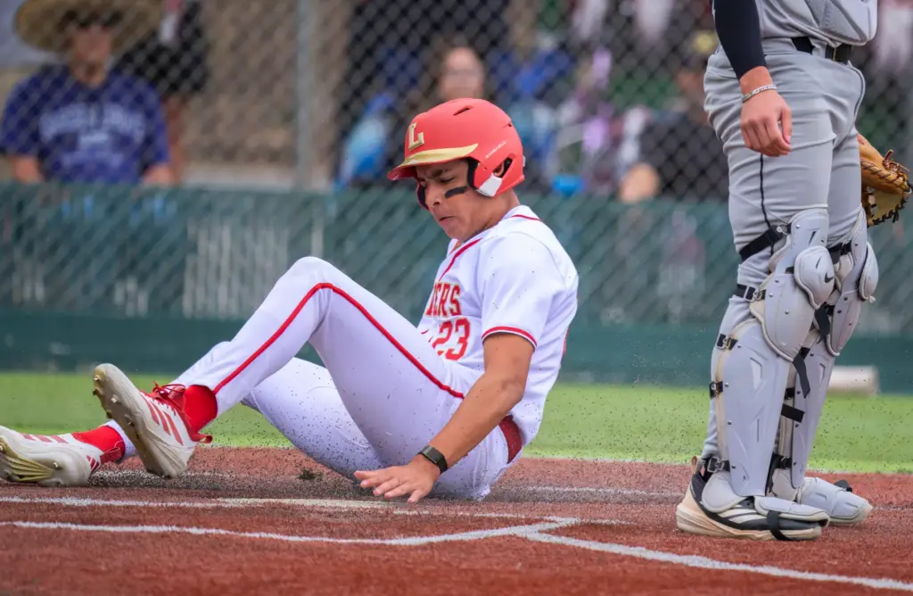 Orange Lutheran’s Ricardo Hurtado scores a run against Santiago of...