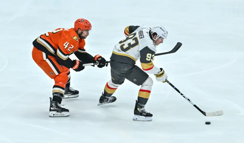 The Ducks’ Tim Washe, left, chases after the Vegas Golden...