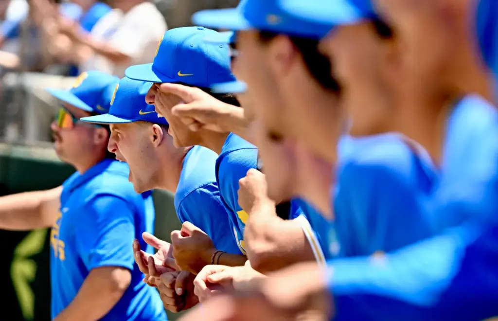 UCLA Bruins bench reacts after a hit against the Virginia...
