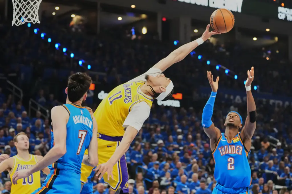 Lakers center Jaxson Hayes reaches to try for a rebound...