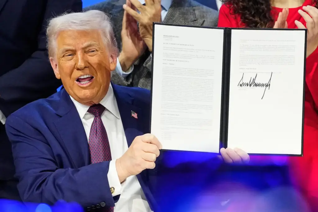 President Donald Trump holds the charter for his Board of Peace initiative.