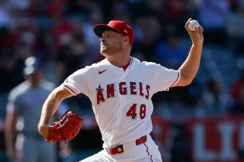 Angels starting pitcher Reid Detmers throws to the plate during...