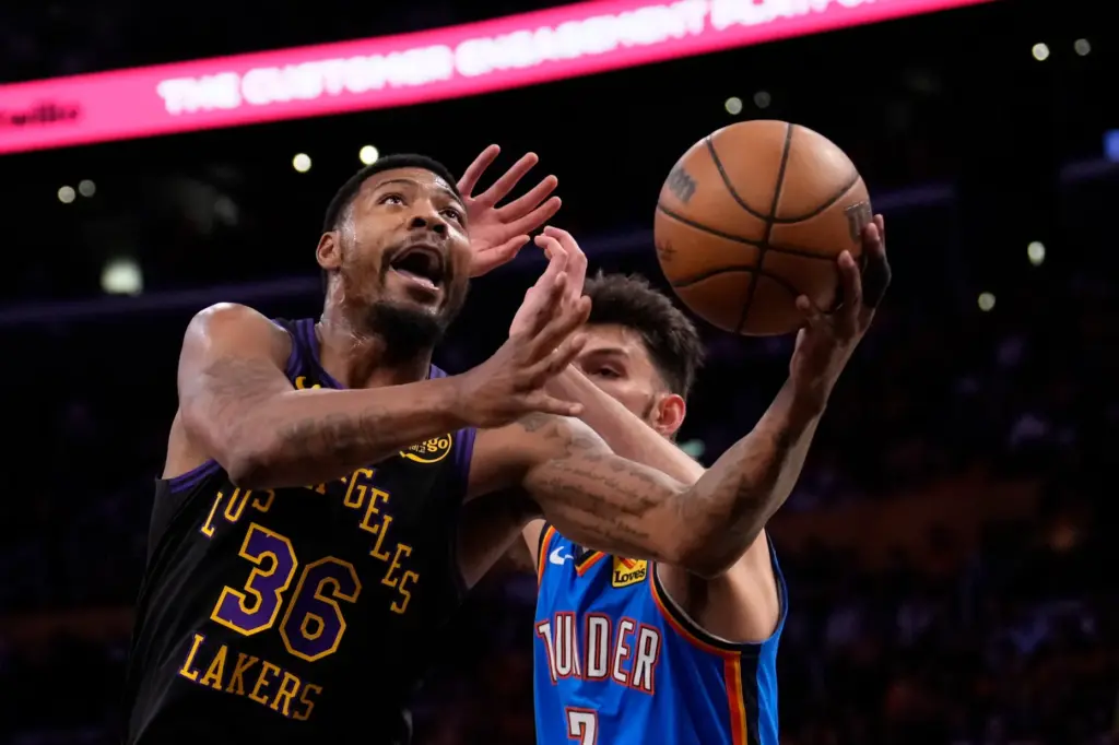 Lakers guard Marcus Smart, left, shoots as Oklahoma City Thunder...