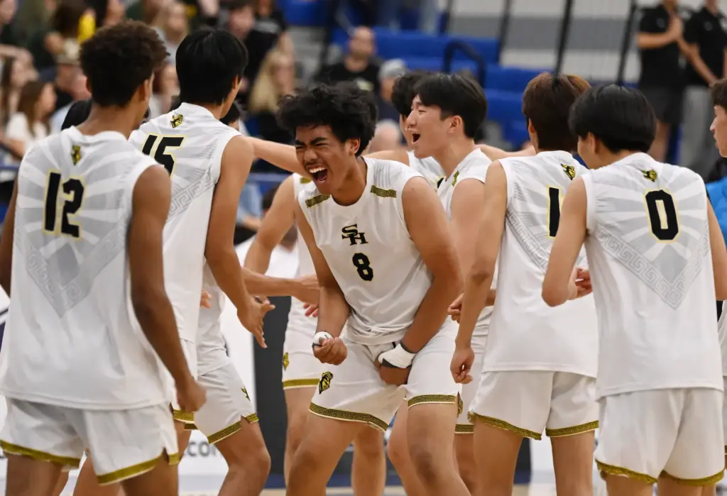 Jadyn Salud #8 of the Sunny Hills Lancers with teammates...