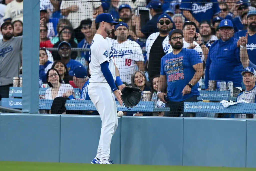 Dodgers right fielder Kyle Tucker lets a foul ball drop...