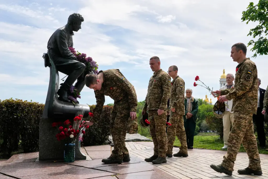 Ukrainian army officers lay flowers at a monument to pilots...