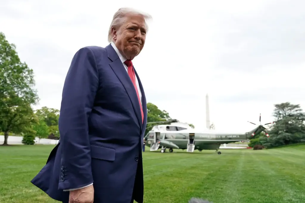President Donald Trump speaks to reporters as he walks to...