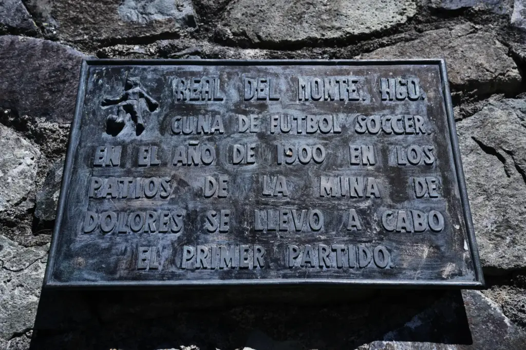 A plaque about soccer hangs on the wall