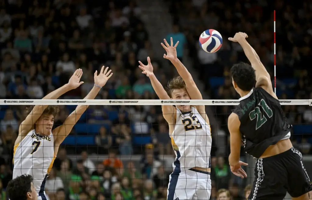 Hawaiiâs Kristian Titriyski, right, spikes the ball as UC Irvine’s...