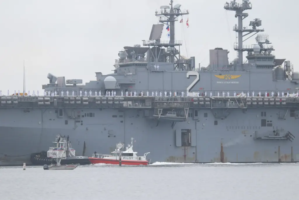 Sailors man the rails as the USS Essex arrives in...