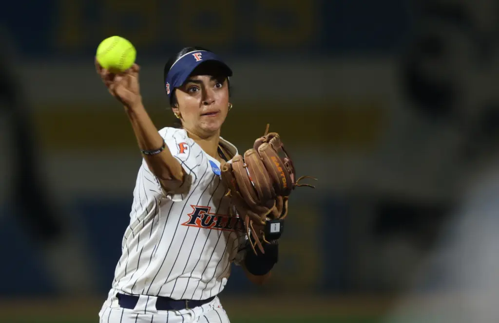 Cal State Fullertonâs Sarah Perez tosses the ball to first...