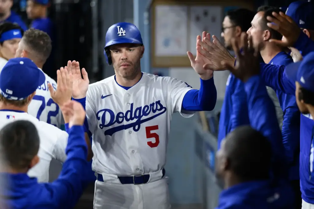 The Dodgers’ Freddie Freeman is greeted in the dugout after...