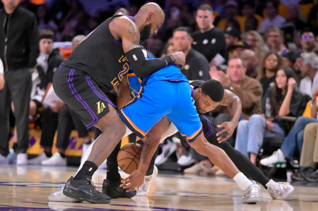 Lakers star LeBron James, left, and guard Marcus Smart, right,...