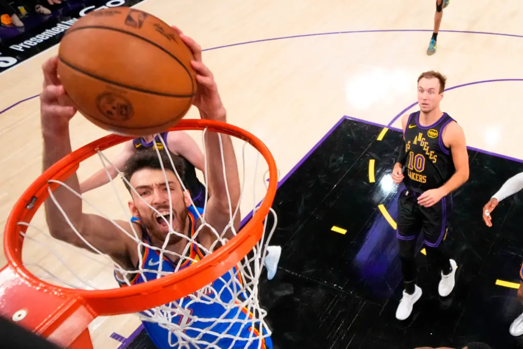 Oklahoma City Thunder center Chet Holmgren, left, dunks as Lakers...