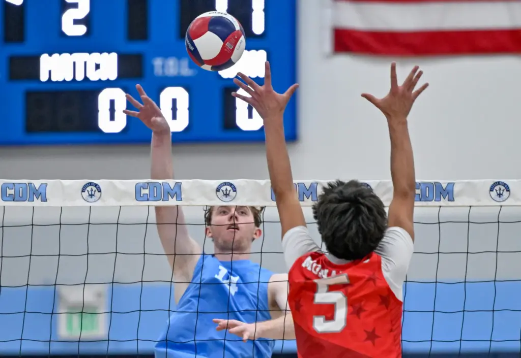 Corona del Mar outside hitter Brady Gant tips the ball...