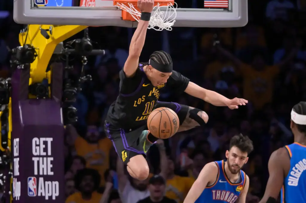 Lakers center Jaxson Hayes hangs on the rim after a...