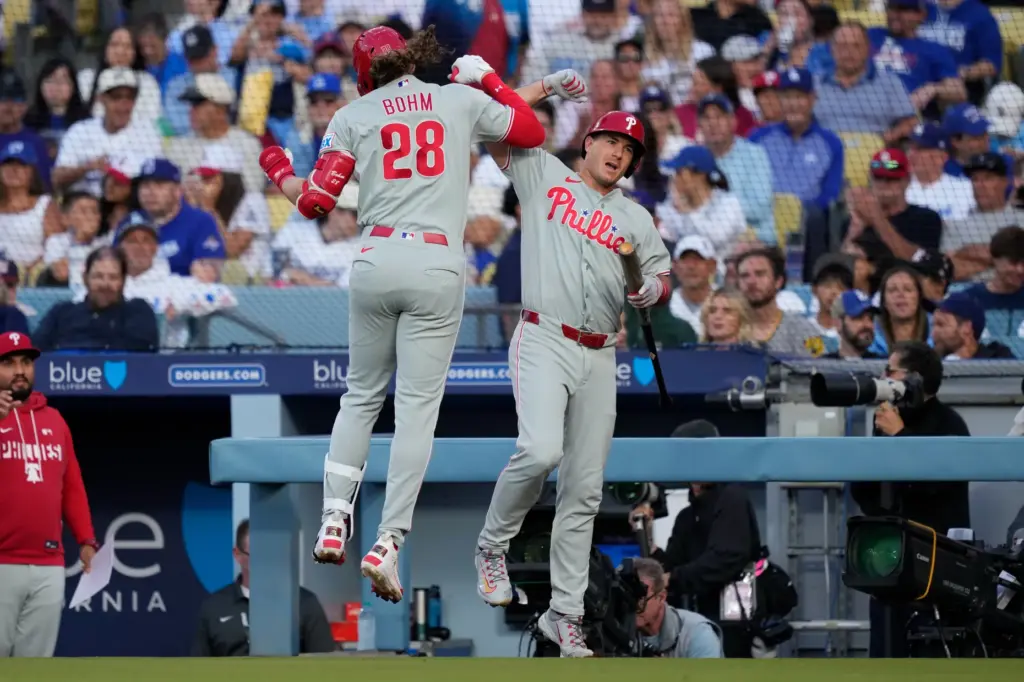 Philadelphia Phillies’ Alec Bohm, left, celebrates his solo home run...