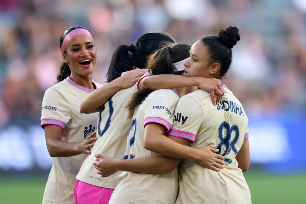 Dudinha and her San Diego Wave FC teammates celebrate her...