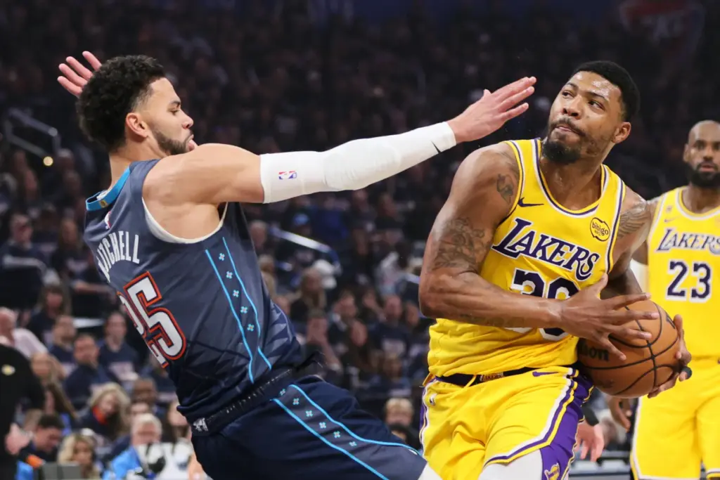 Los Angeles Lakers guard Marcus Smart, right, drives to the...