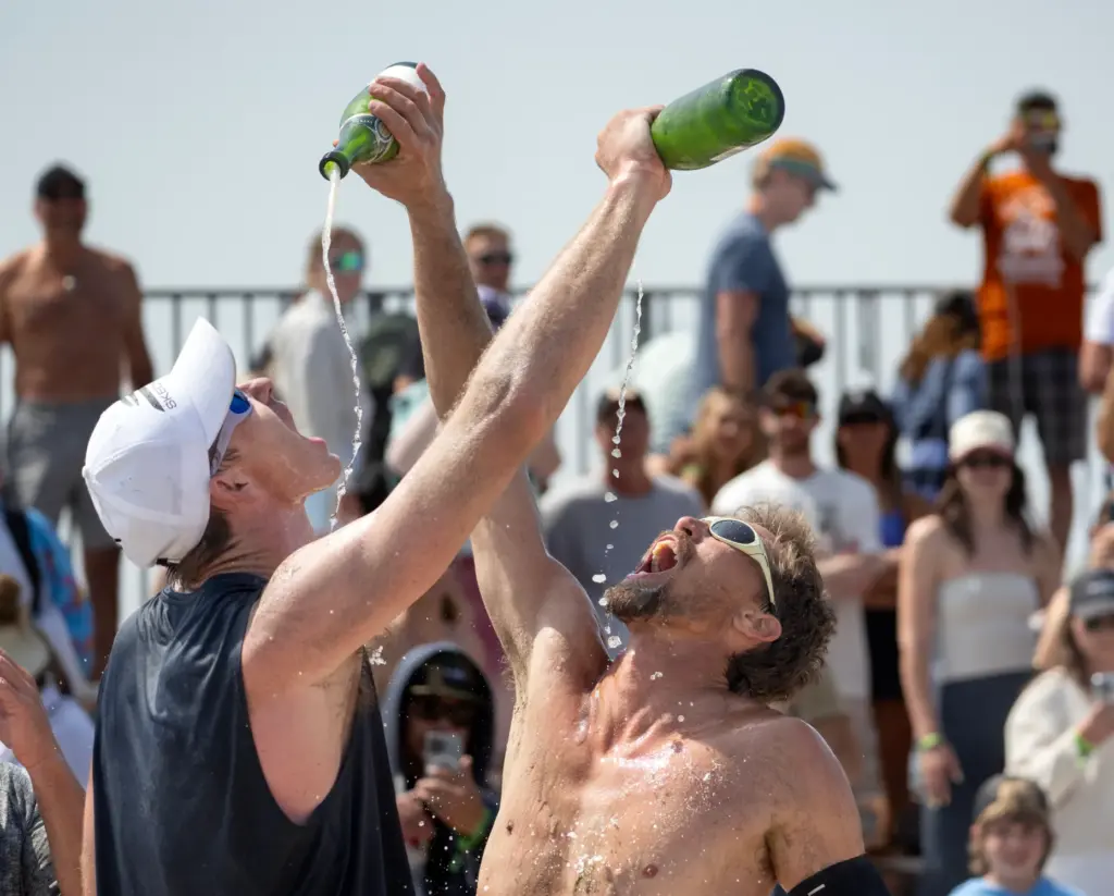 Andy Benesh, left, and Taylor Crabb celebrate their AVP menâs...