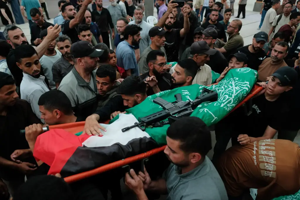 Palestinians carry a body