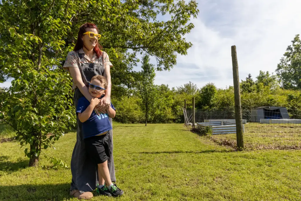 Ashley Caudle, a citizen of the Cherokee Nation, wraps her arms around her son, Elliot,