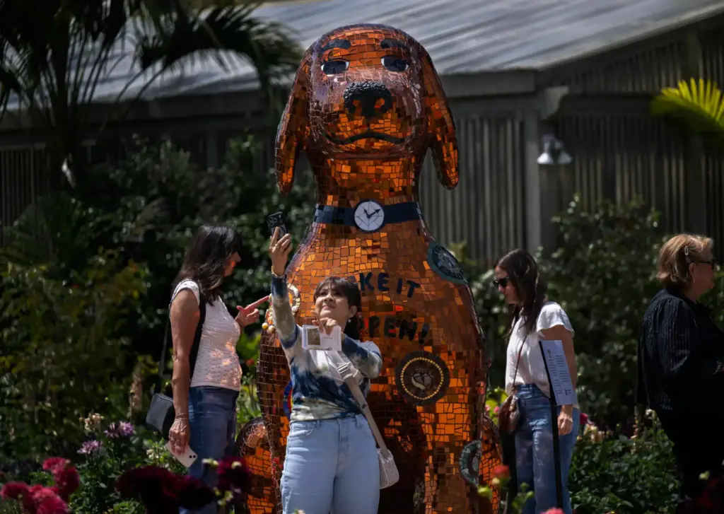 Abby Quintana, center, of Irvine snaps a selfie with Honey,...