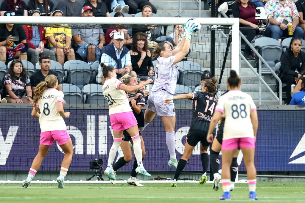 Angel City FC goalkeeper Angelina Anderson, top, catches the ball...