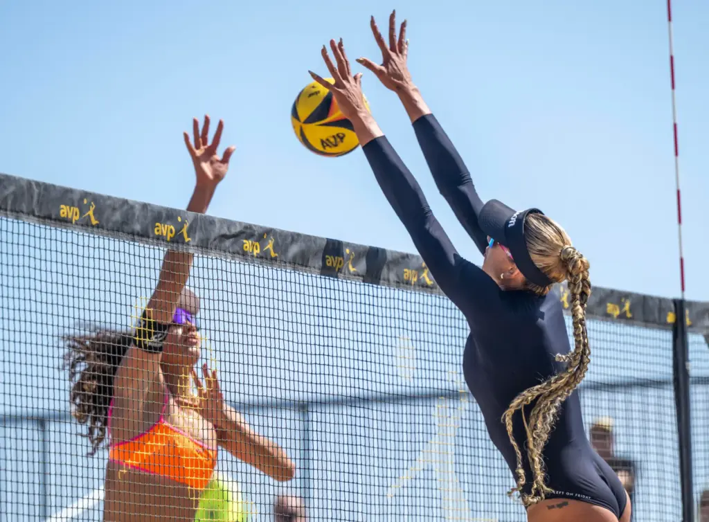 Brandie Wilkerson, right, puts up a big block against a...