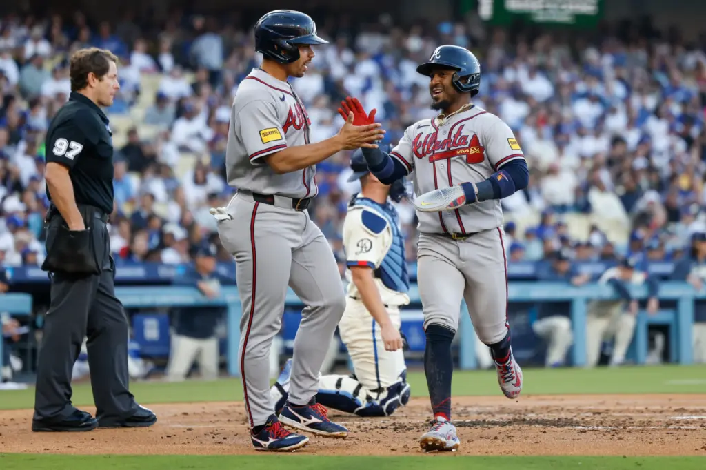 Atlanta Braves designated hitter Drake Baldwin, center left, greets teammate...
