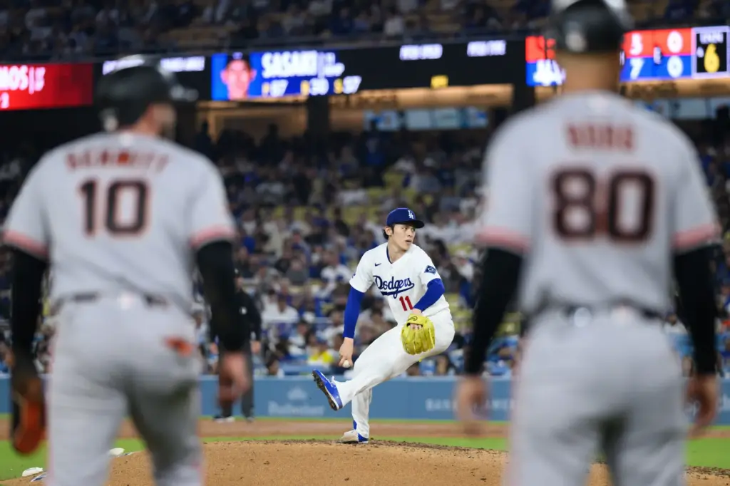 Dodgers starting pitcher Roki Sasaki throws to the plate during...