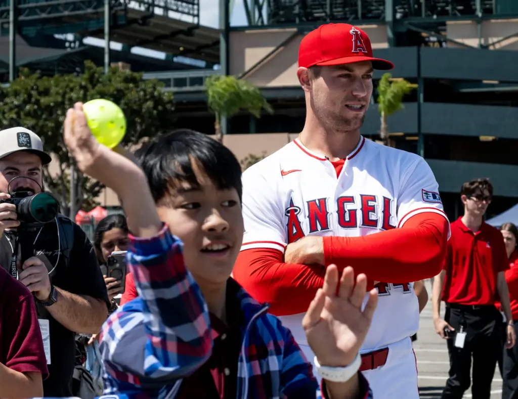 Angels pitcher Ben Joyce watches a student throw during STEAM...