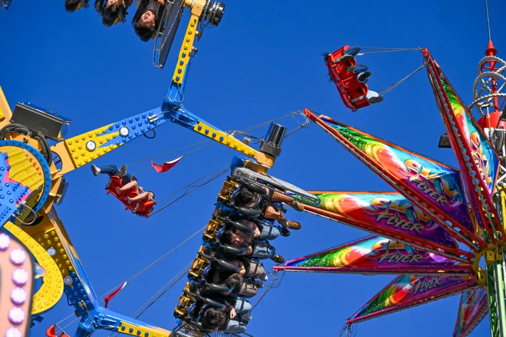 Fairgoers enjoy the rides during the final weekend of the...