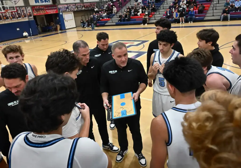 Corona del Marâs Head Coach Jason Simco talks to his...
