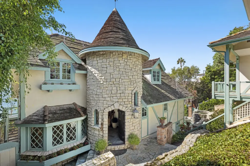 The main house has a stone-clad turret entry. (Photo by...
