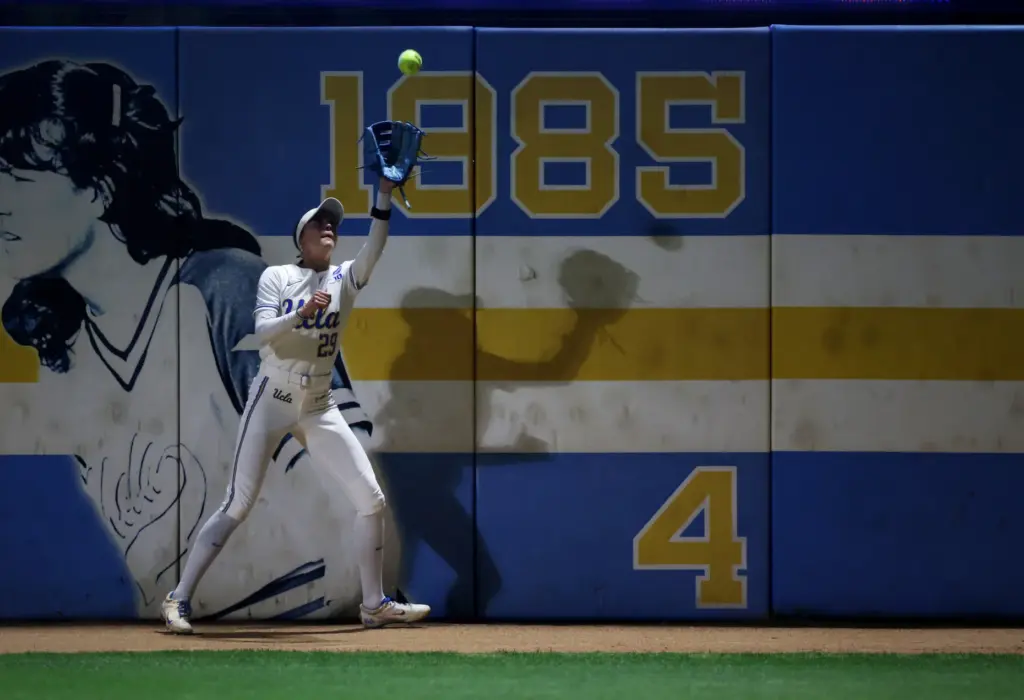 UCLAâs Rylee Slimp catches a fly ball for an out...