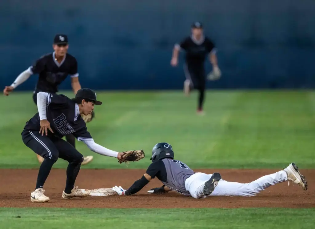 Glendora infielder Santiago Garza slides safely into second base, avoiding...