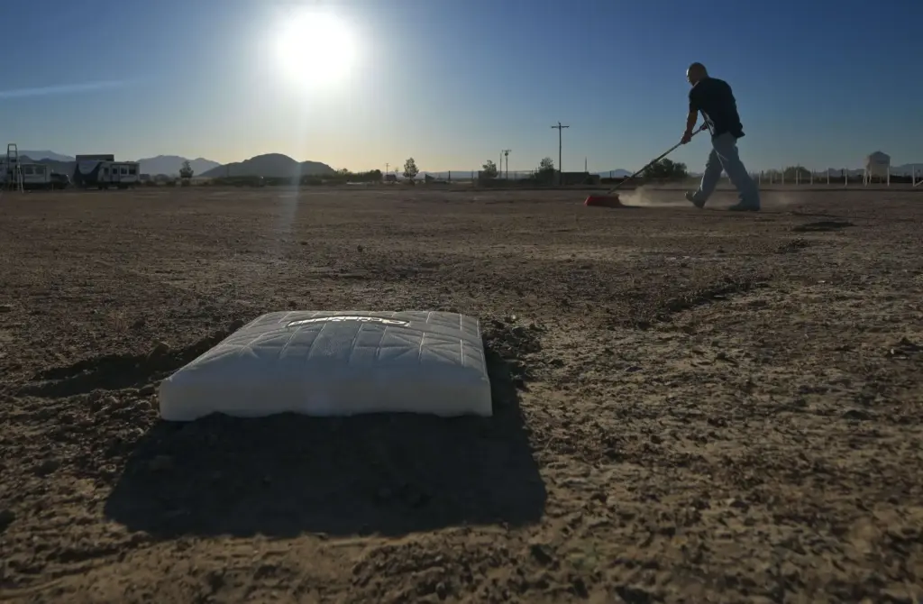 âRancherâ Raymond Ramirez, 43, of San Bernardino, grooms a softball...