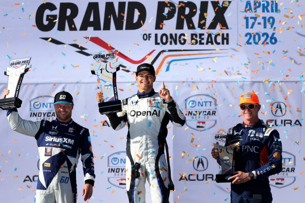 Winning Indycar driver Alex Plaou, center, celebrates alongside second place...