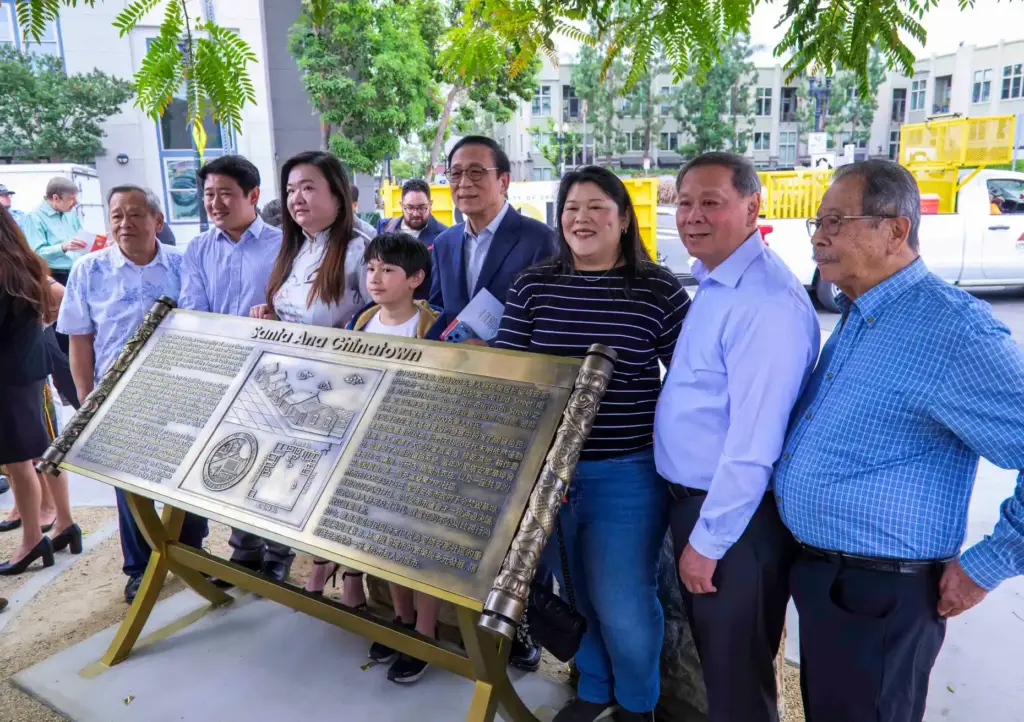 Members of the Lau family gather for a photo around...