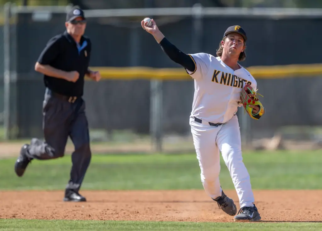 Foothill third baseman Evrett Rycroft throws to first base after...