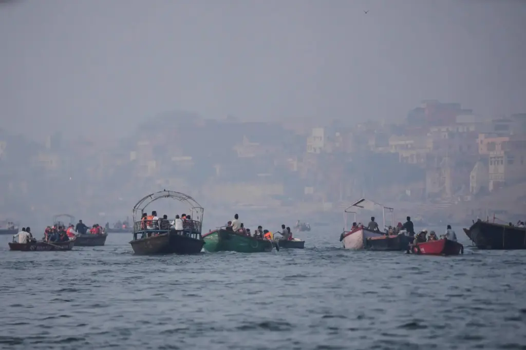 FILE – Tourists take a boat ride early morning in...