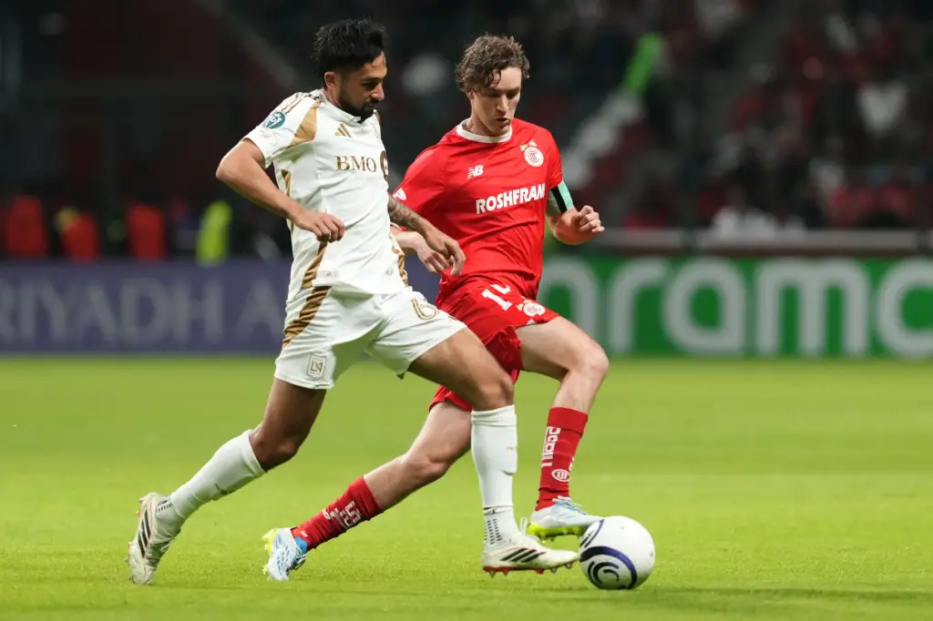 LAFC’s Mathieu Choiniere, left, and Toluca FC’s Marcel Ruiz compete...